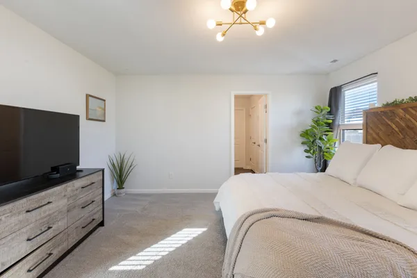 a bedroom with a bed and flat screen tv