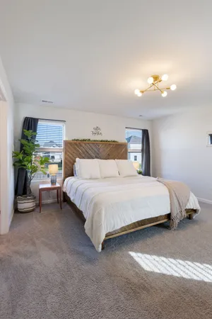 a bedroom with a bed and a lamp