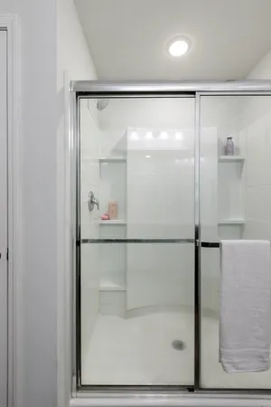 a bathroom with a glass shower door