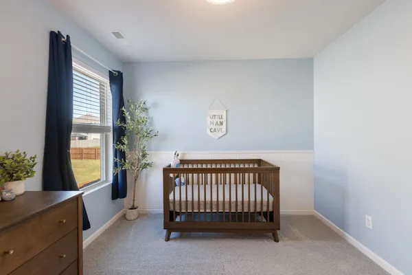a view of a bedroom with furniture and windows