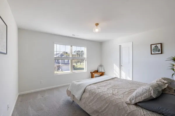 a bedroom with a bed and window