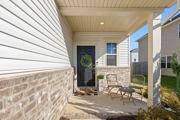 a view of front door of house with outdoor seating