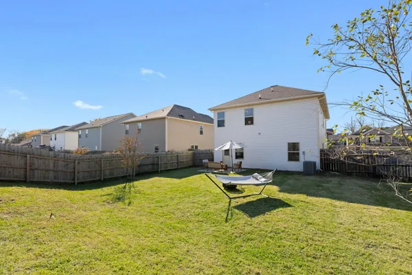 a swimming pool with outdoor seating and yard