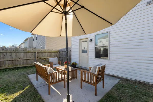 a view of a patio with a table and chairs