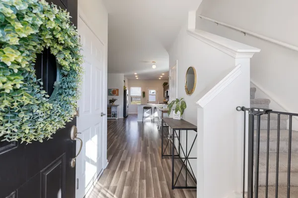a view of entryway and hall with wooden floor