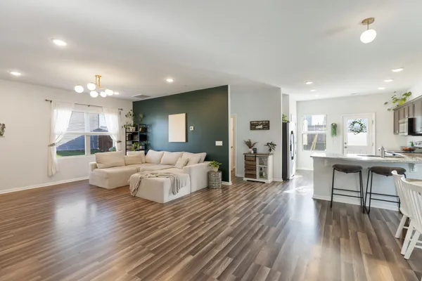 a living room with furniture and a wooden floor