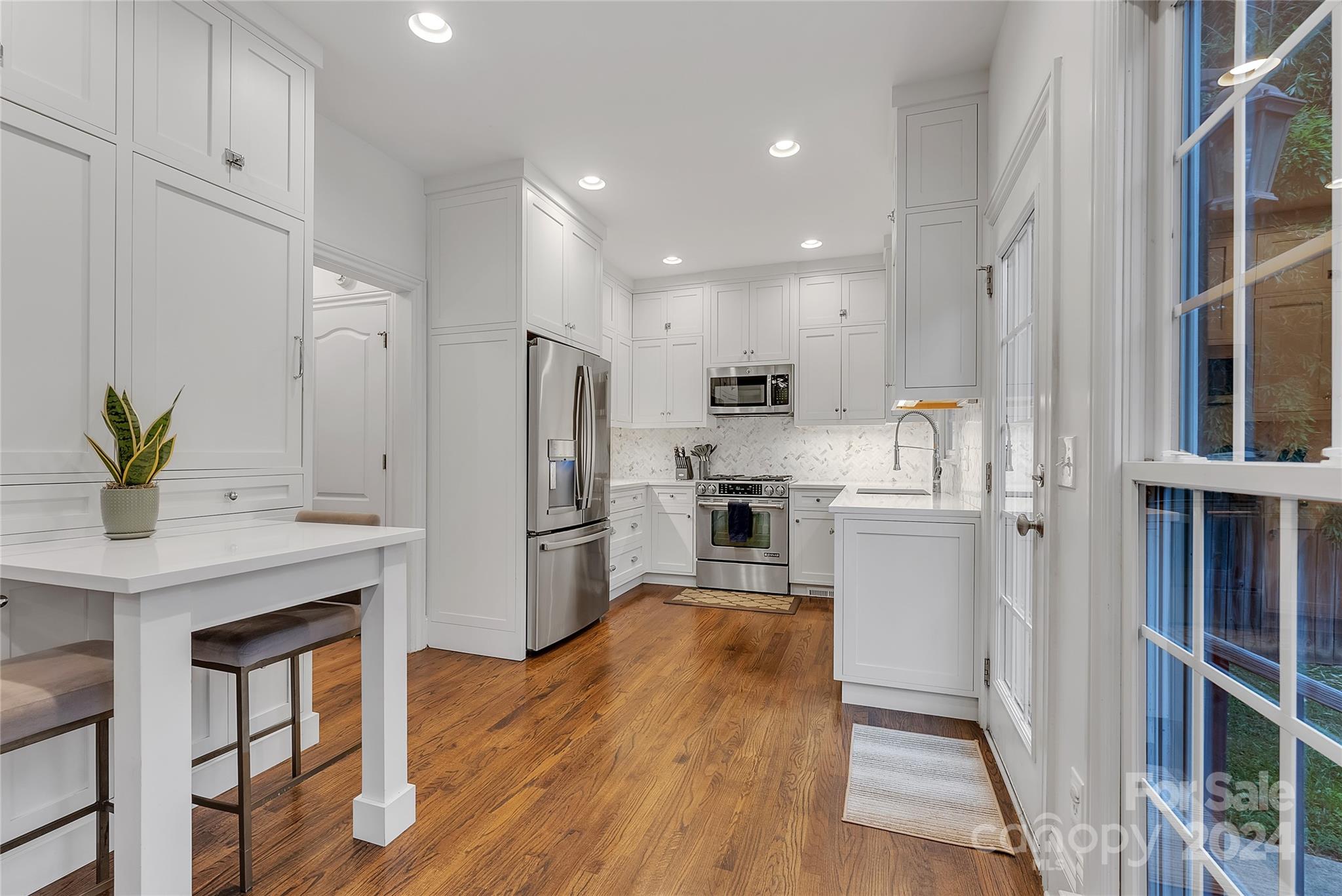 920 Millbrook Road Charlotte, NC 28211 - Photo 15 of 48 a kitchen with white cabinets and stainless steel appliances