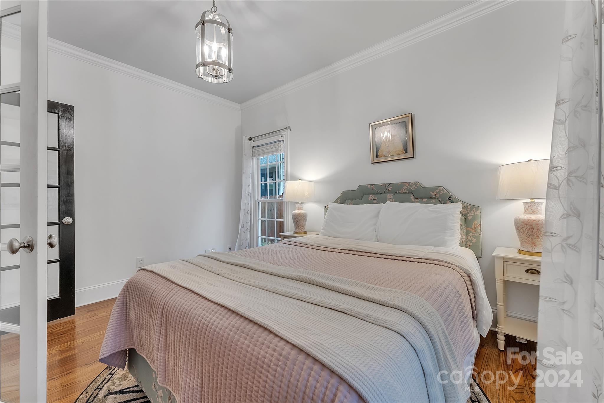 920 Millbrook Road Charlotte, NC 28211 - Photo 17 of 48 a bedroom with a bed and a chandelier