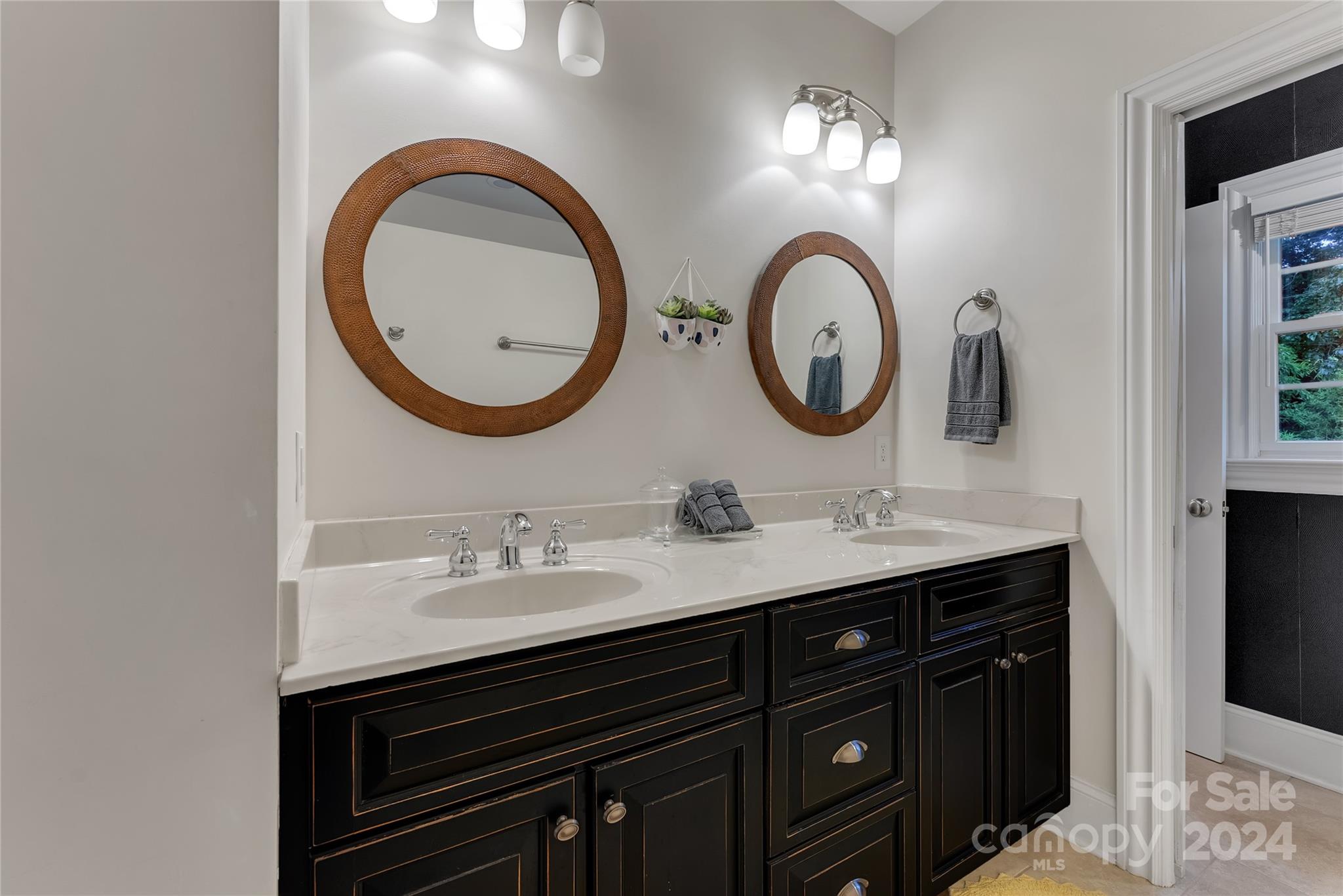 920 Millbrook Road Charlotte, NC 28211 - Photo 26 of 48 a bathroom with a sink and a mirror