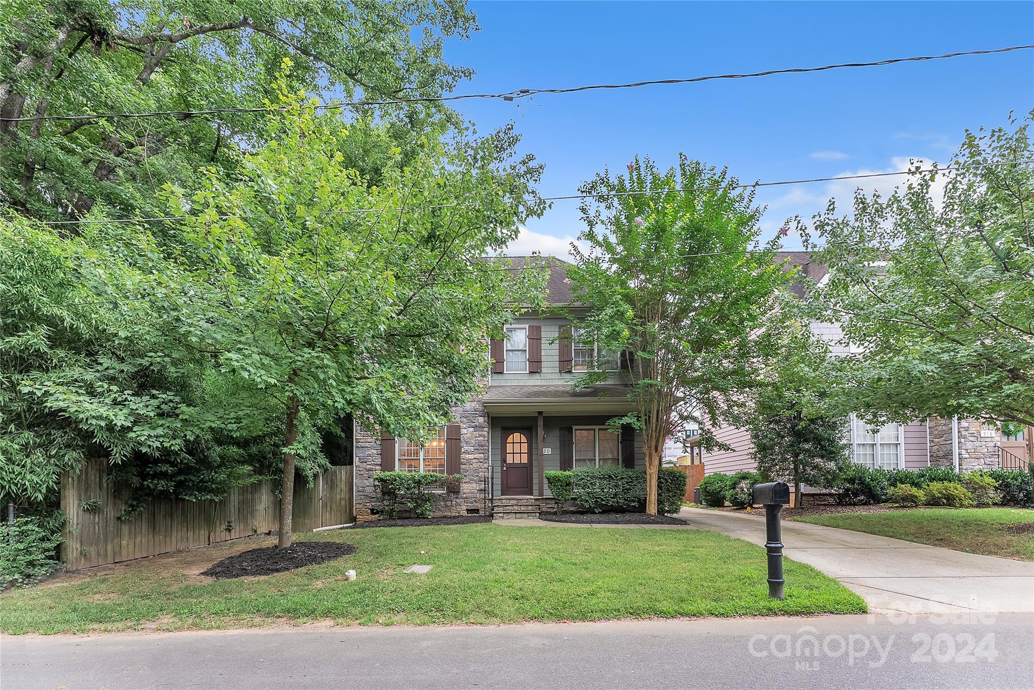 920 Millbrook Road Charlotte, NC 28211 - Photo 3 of 48 a view of a brick house with a big yard and large trees