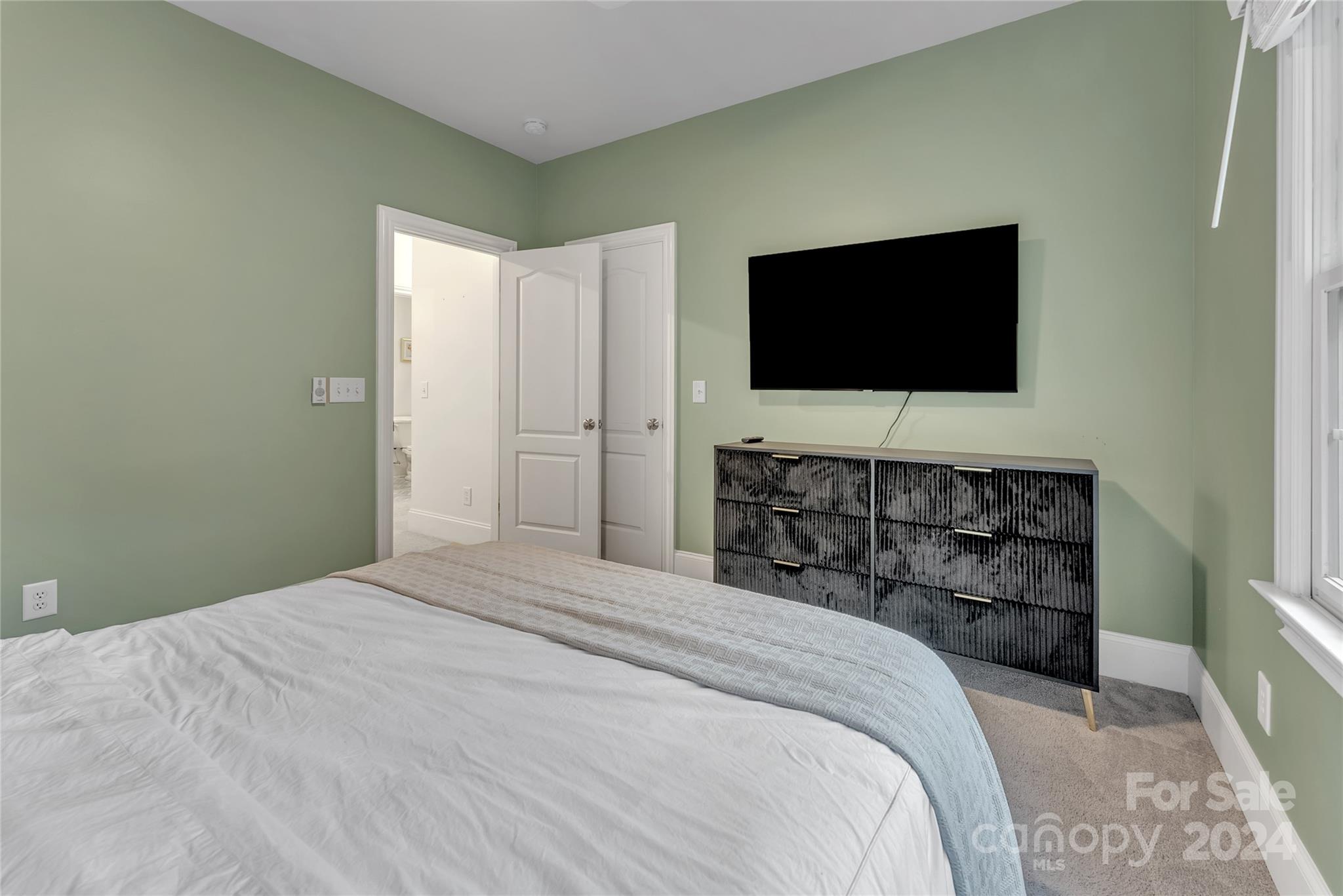 920 Millbrook Road Charlotte, NC 28211 - Photo 32 of 48 a bedroom with a bed and a flat screen tv