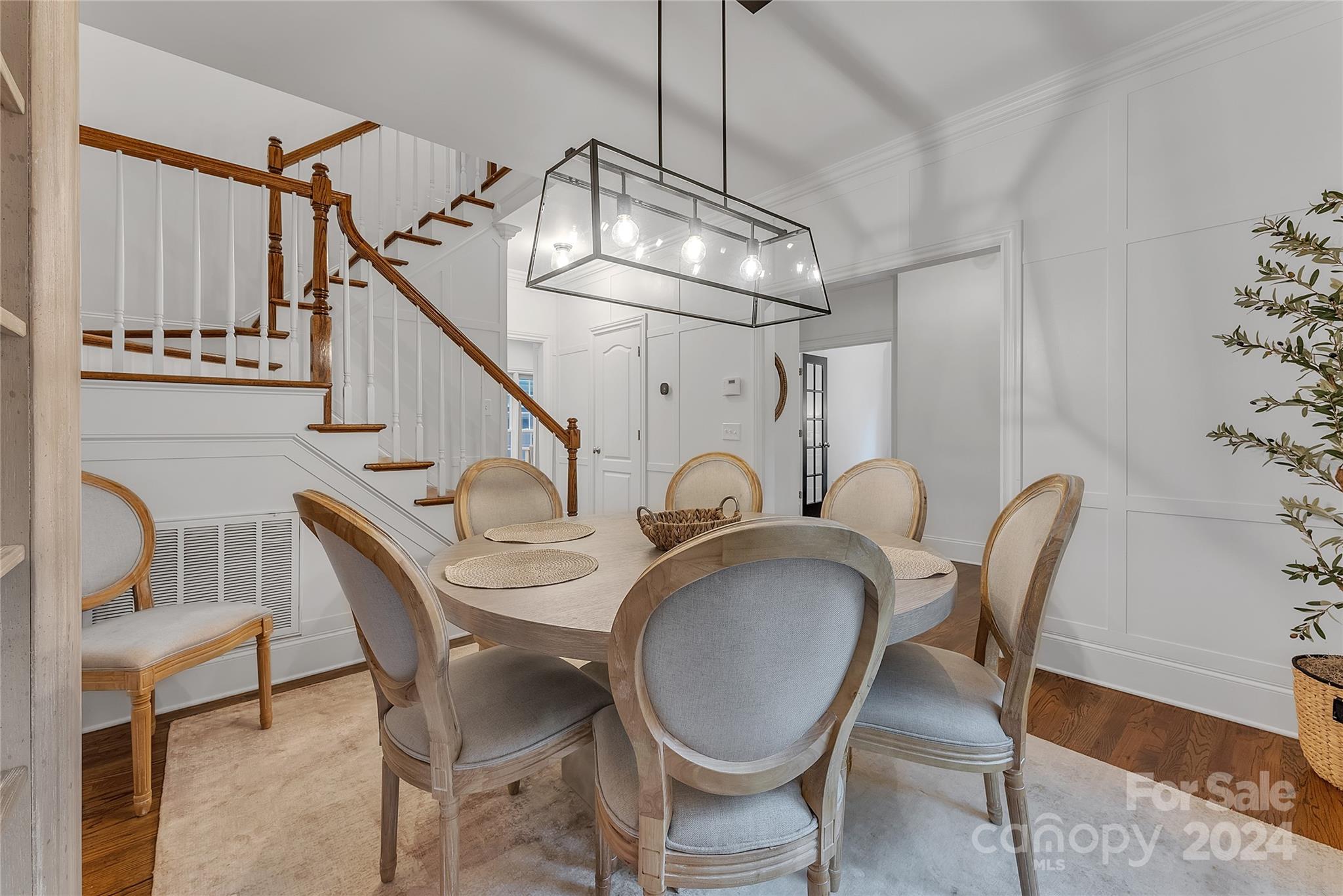 920 Millbrook Road Charlotte, NC 28211 - Photo 7 of 48 a dining room with furniture a chandelier and wooden floor