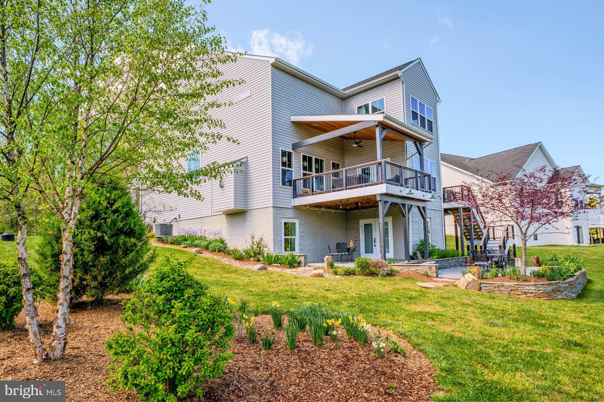 18120 Ridgewood Place Round Hill, VA 20141 - Photo 39 of 46 a view of a big house with a big yard plants and large trees