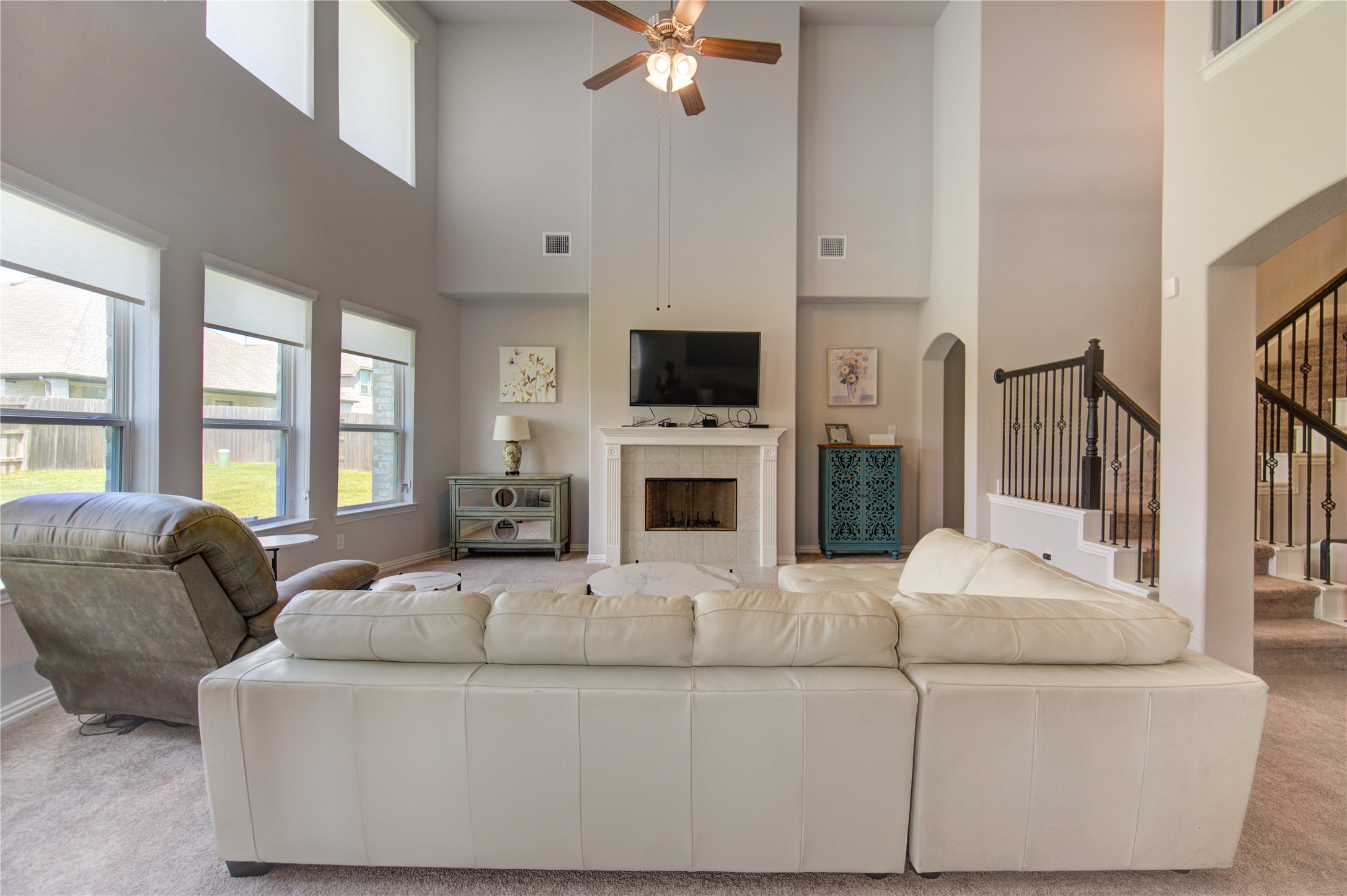 13838 Sturcombe Gln Trail Rosharon, TX 77583 - Photo 11 of 44 a living room with furniture a fireplace and a flat screen tv
