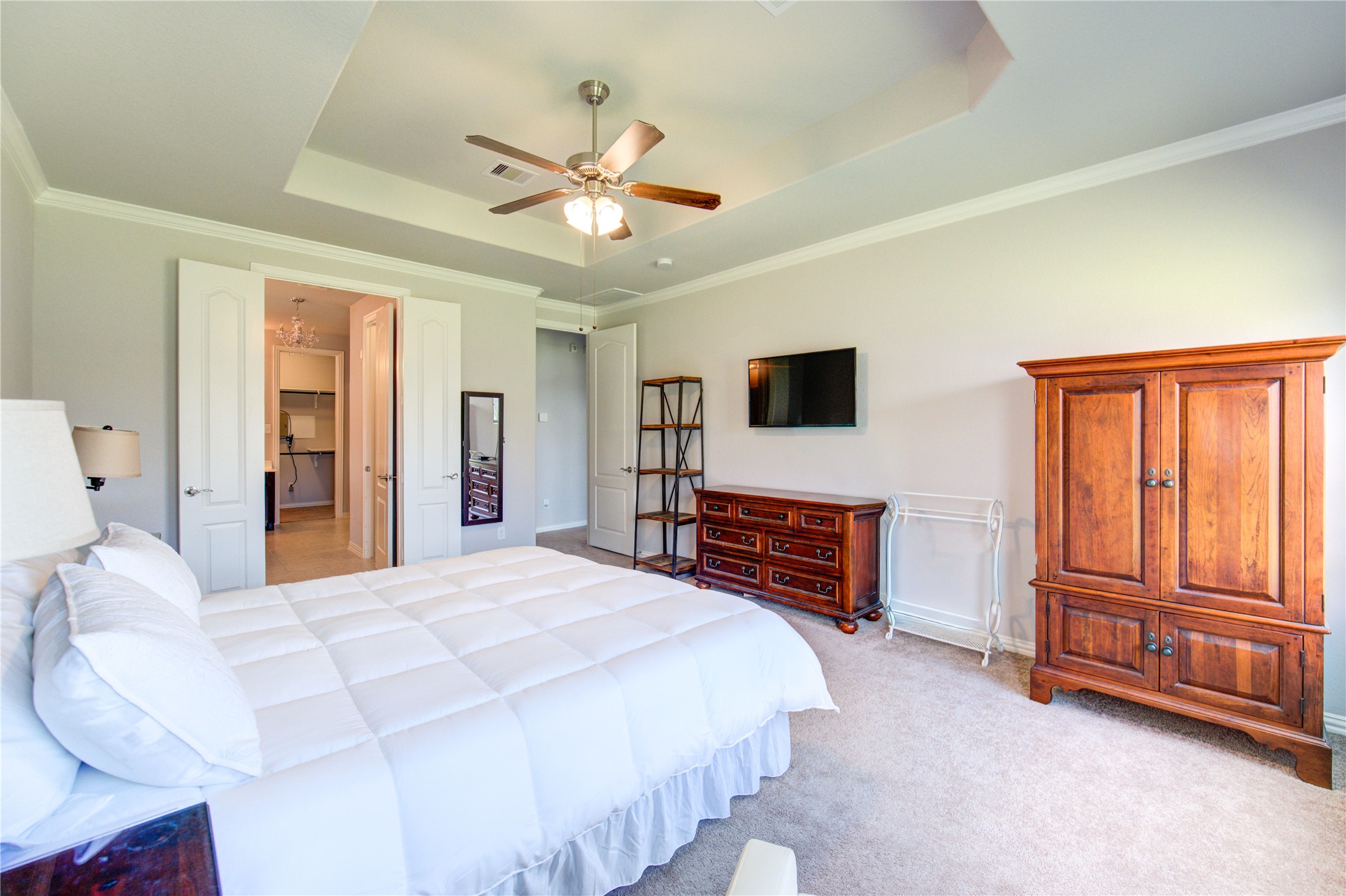 13838 Sturcombe Gln Trail Rosharon, TX 77583 - Photo 18 of 44 a bedroom with a bed dresser and a flat tv screen