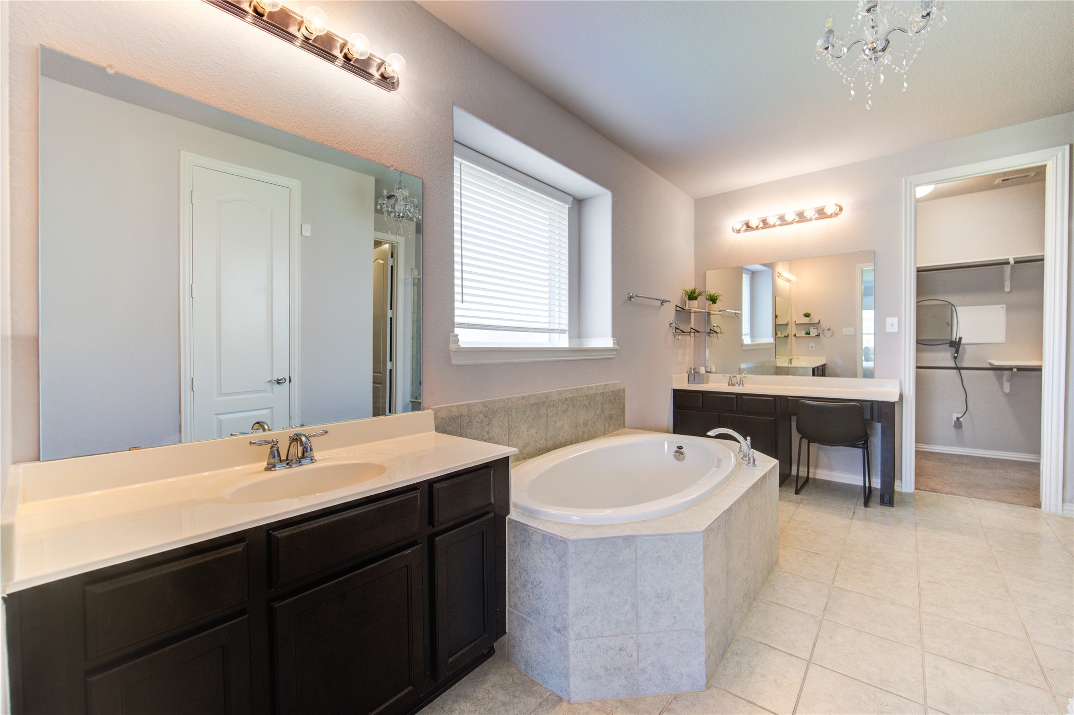 13838 Sturcombe Gln Trail Rosharon, TX 77583 - Photo 21 of 44 a bathroom with a tub a sink double vanity and a mirror