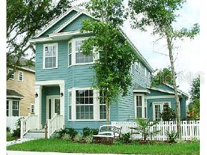 a front view of a house with a yard and trees