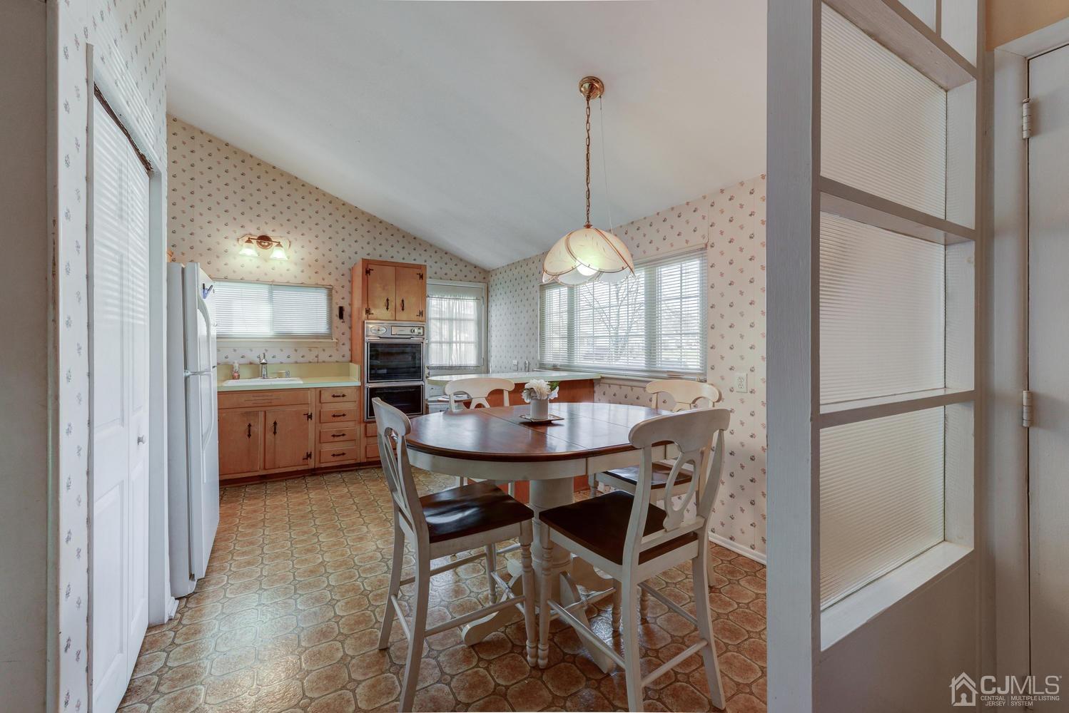 85 Albemarle Road Colonia, NJ 07067 - Photo 14 of 29 a view of a dining room with furniture and a chandelier