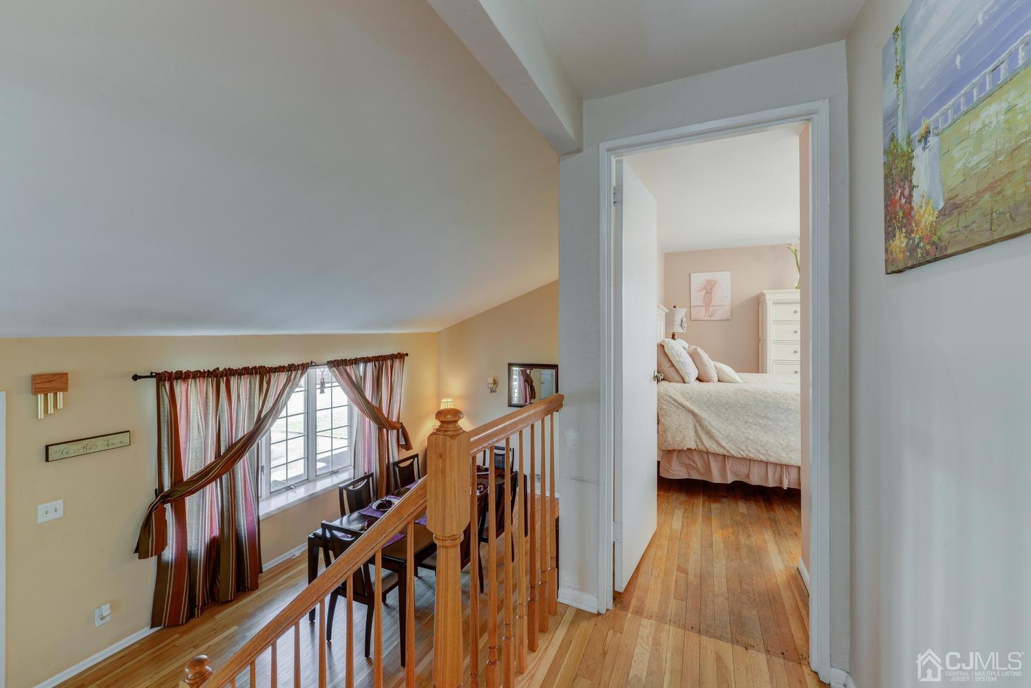 85 Albemarle Road Colonia, NJ 07067 - Photo 19 of 29 a view of a hallway with wooden floor and staircase