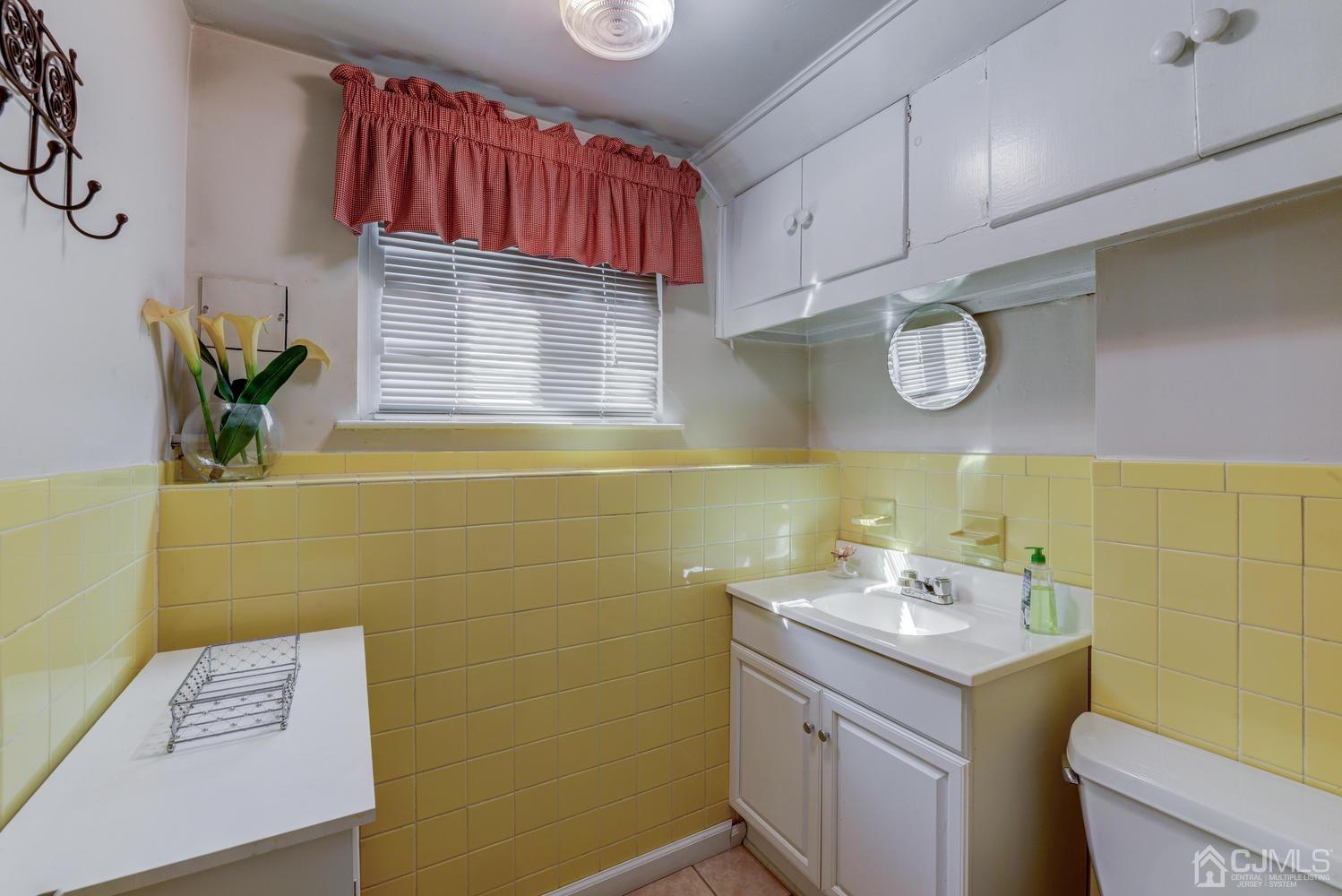 85 Albemarle Road Colonia, NJ 07067 - Photo 23 of 29 a bathroom with a sink a mirror and a toilet