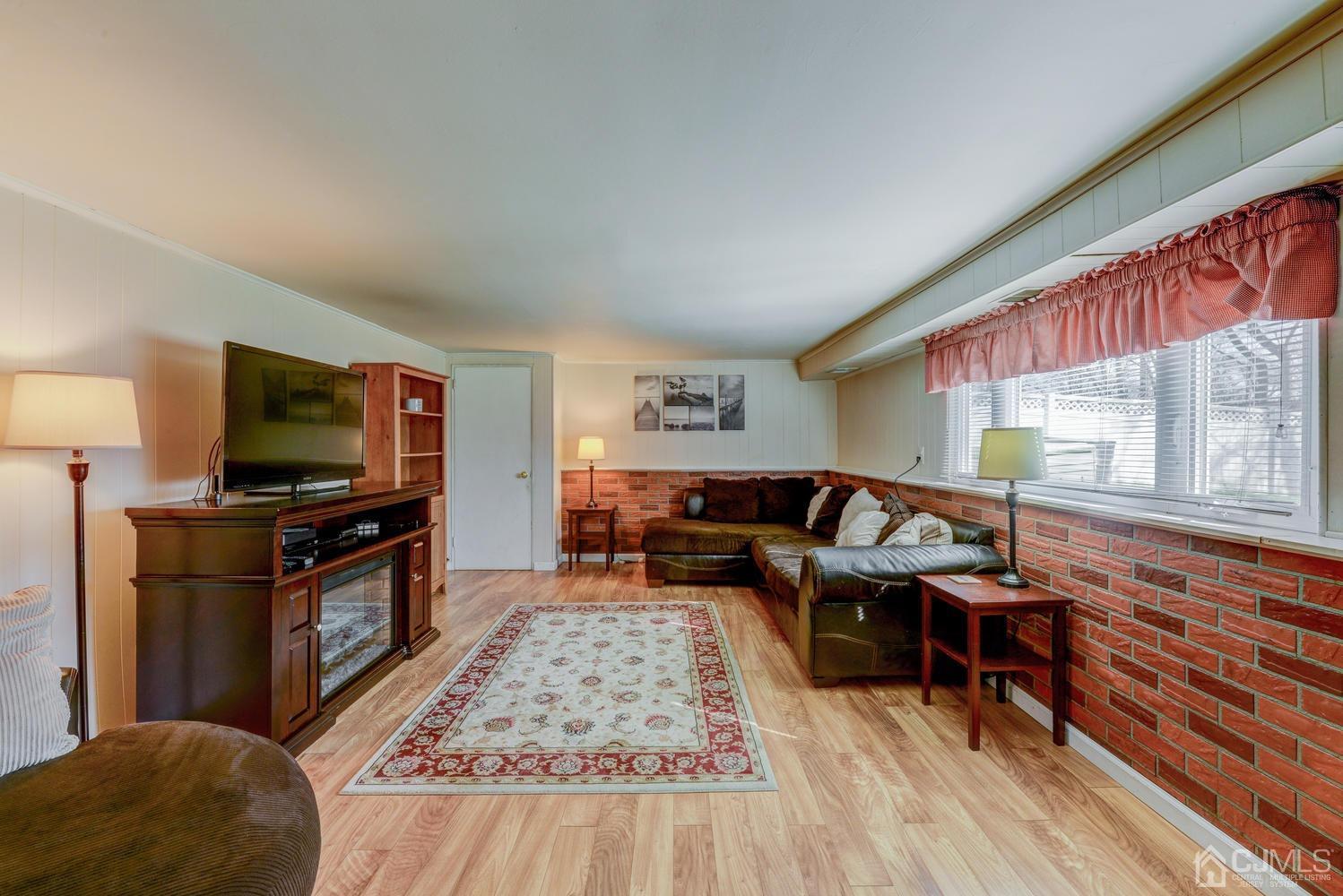 85 Albemarle Road Colonia, NJ 07067 - Photo 7 of 29 a living room with furniture and a flat screen tv