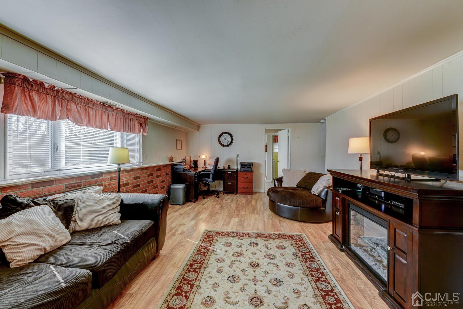 85 Albemarle Road Colonia, NJ 07067 - Photo 8 of 29 a living room with furniture and a flat screen tv