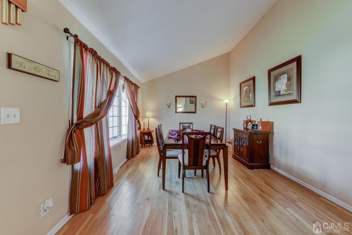 85 Albemarle Road Colonia, NJ 07067 - Photo 10 of 29 a dining room with wooden floor windows and furniture