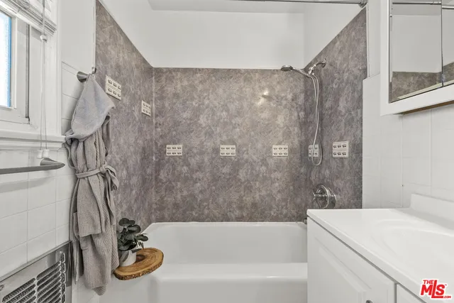 a bathroom with a sink a bathtub and a shower