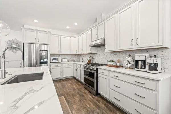 a kitchen with kitchen island granite countertop lots of counter top space and sink