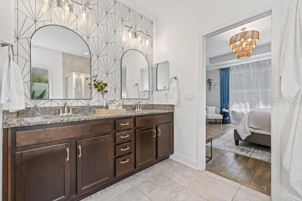 a bathroom with a granite countertop sink a toilet and a mirror