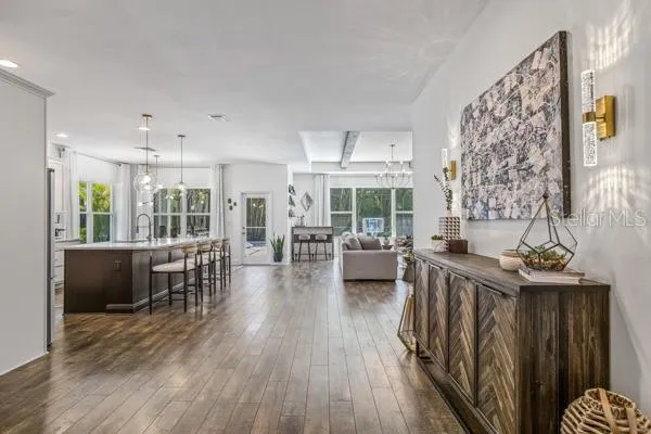 a living room with furniture and view of kitchen