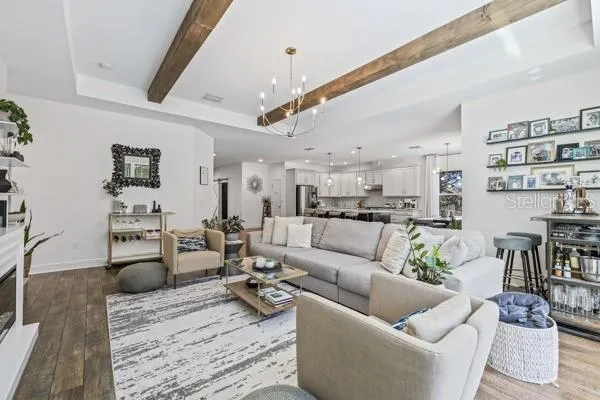 a living room with furniture potted plant and a large window