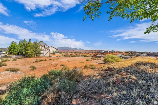 446 Quail Drive Washington, UT 84780 - Photo 11 of 12 Expansive undeveloped lot featuring natural desert vegetation and distant mountain ranges