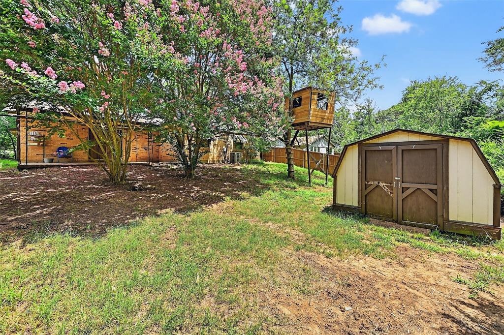 813 Glen Key Street Denison, TX 75020 - Photo 23 of 24 a backyard of a house with lots of green space and fountain
