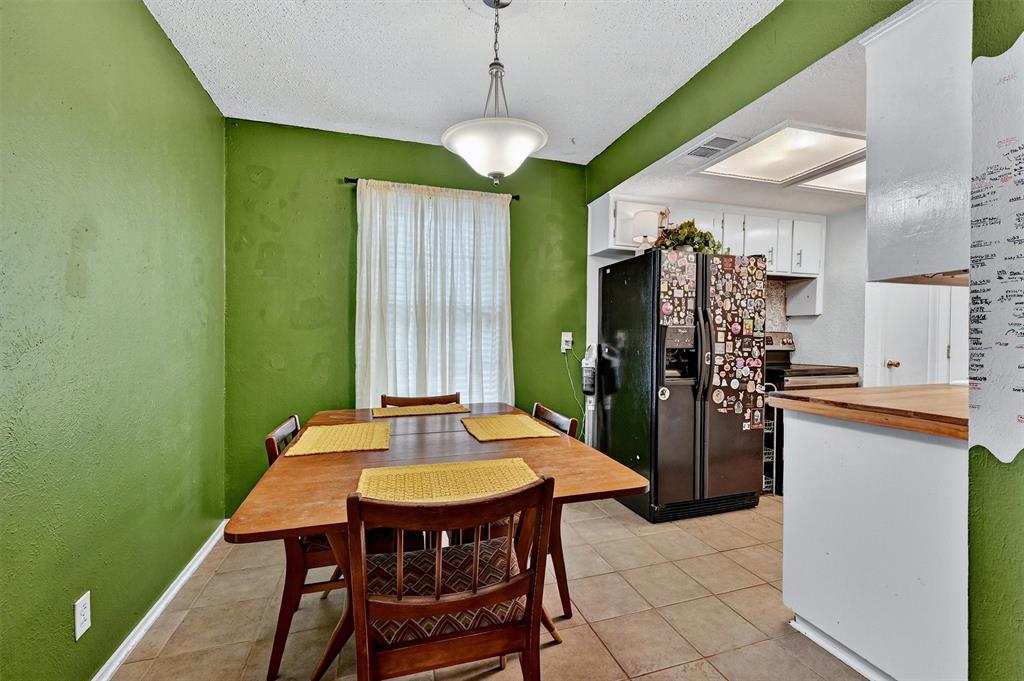 813 Glen Key Street Denison, TX 75020 - Photo 8 of 24 a dining room with stainless steel appliances a table and chairs