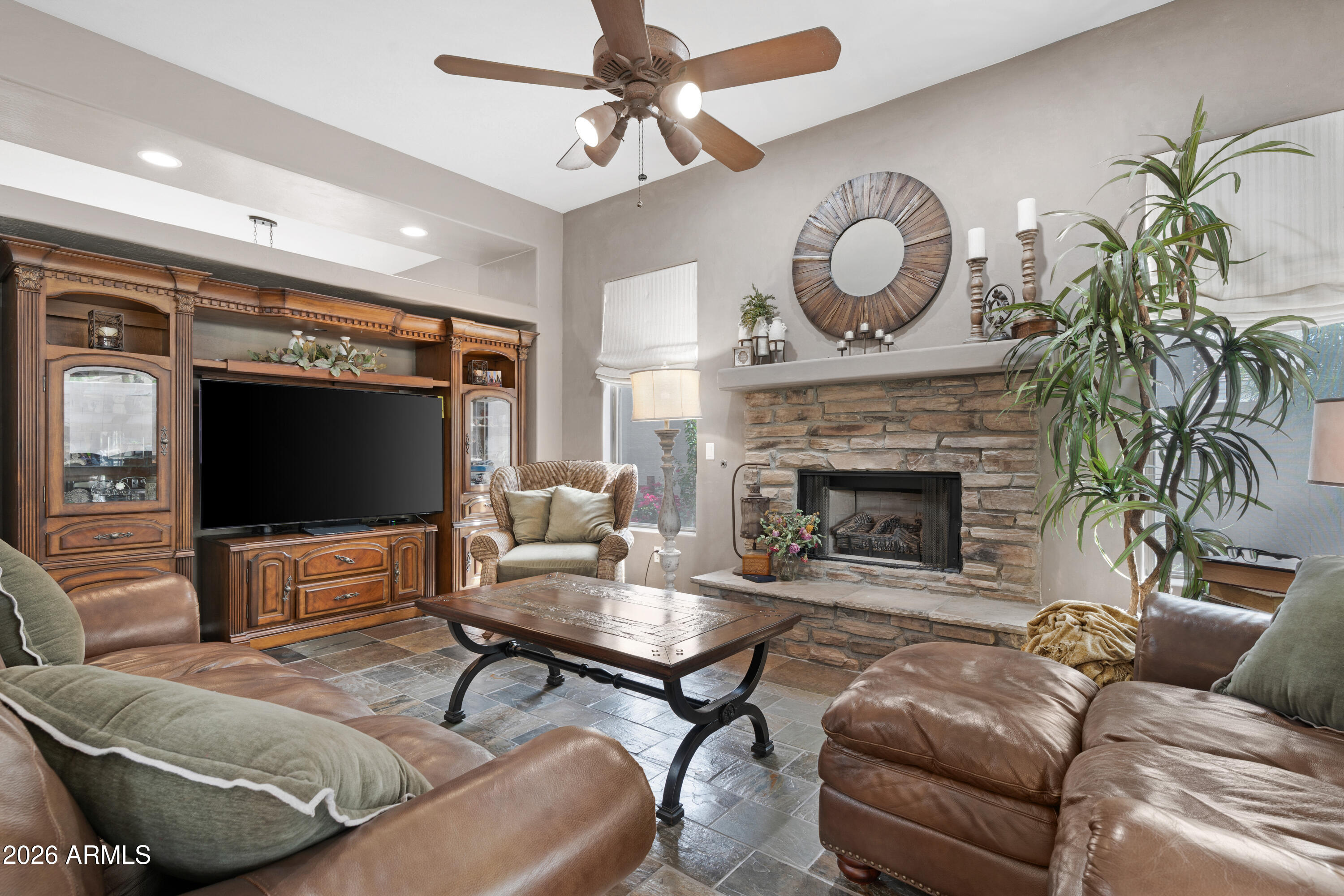 2107 East Beautiful Lane Phoenix, AZ 85042 - Photo 10 of 36 a living room with furniture a flat screen tv and a fireplace