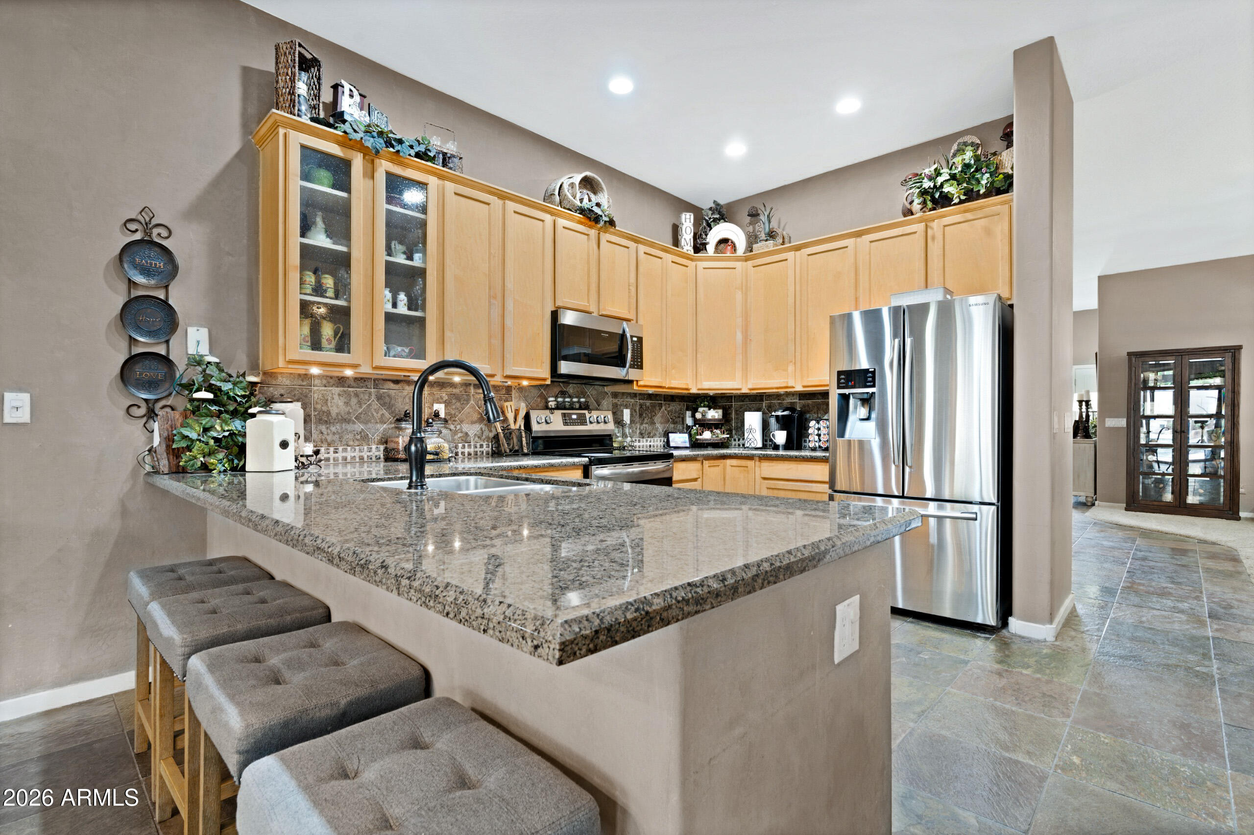 2107 East Beautiful Lane Phoenix, AZ 85042 - Photo 11 of 36 a kitchen with stainless steel appliances granite countertop a refrigerator a stove and a sink