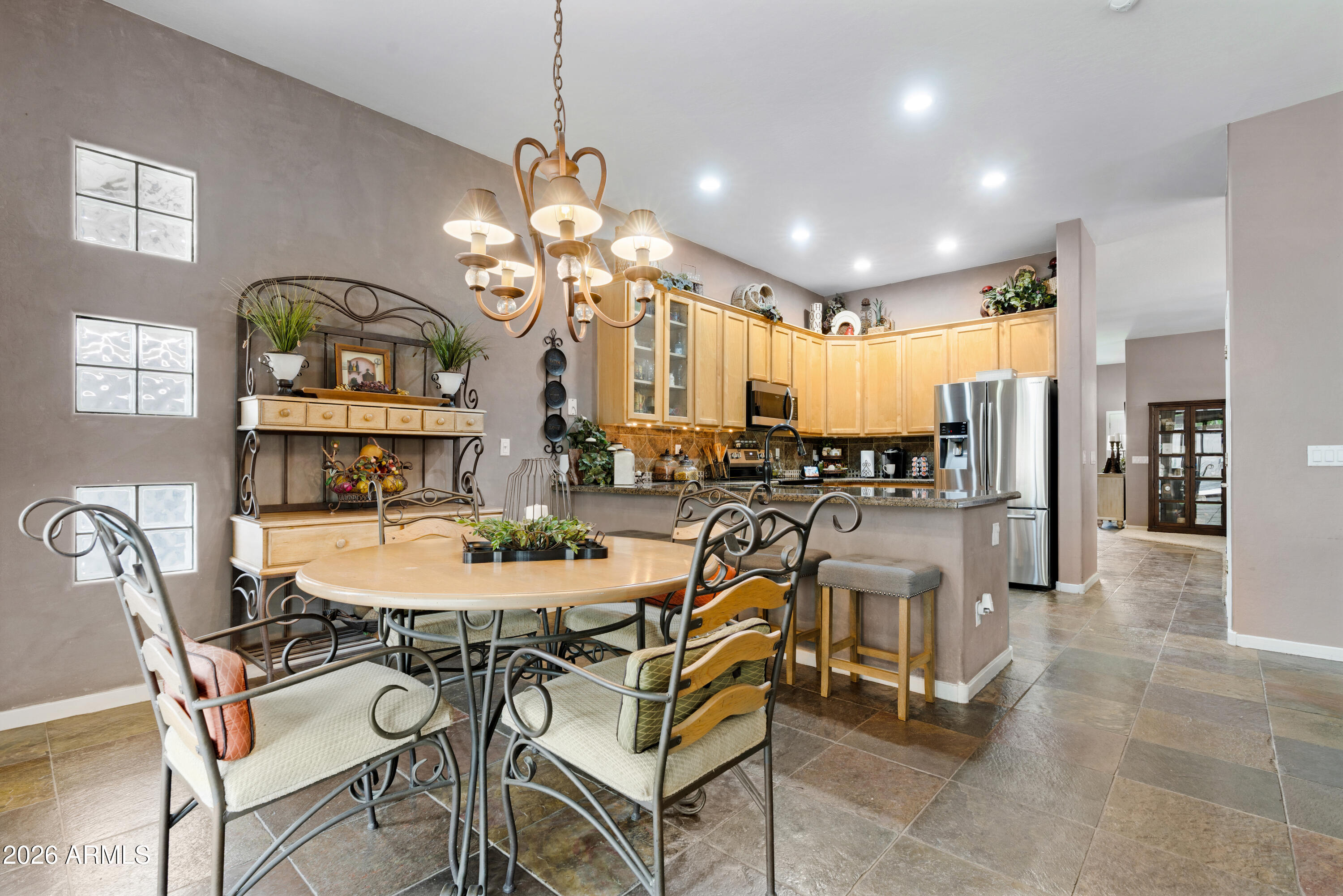 2107 East Beautiful Lane Phoenix, AZ 85042 - Photo 16 of 36 a view of a dining room with furniture and a chandelier