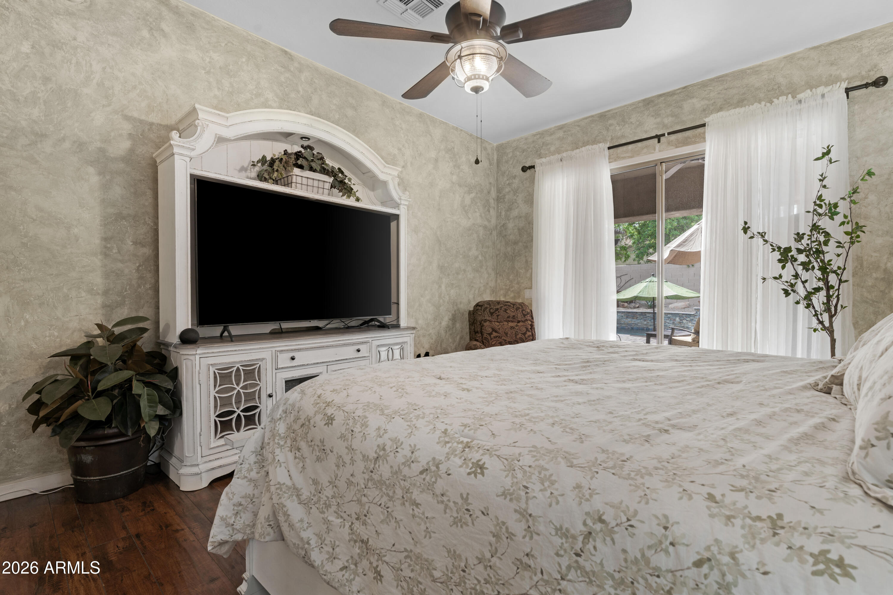 2107 East Beautiful Lane Phoenix, AZ 85042 - Photo 19 of 36 a bedroom with a bed and a flat screen tv
