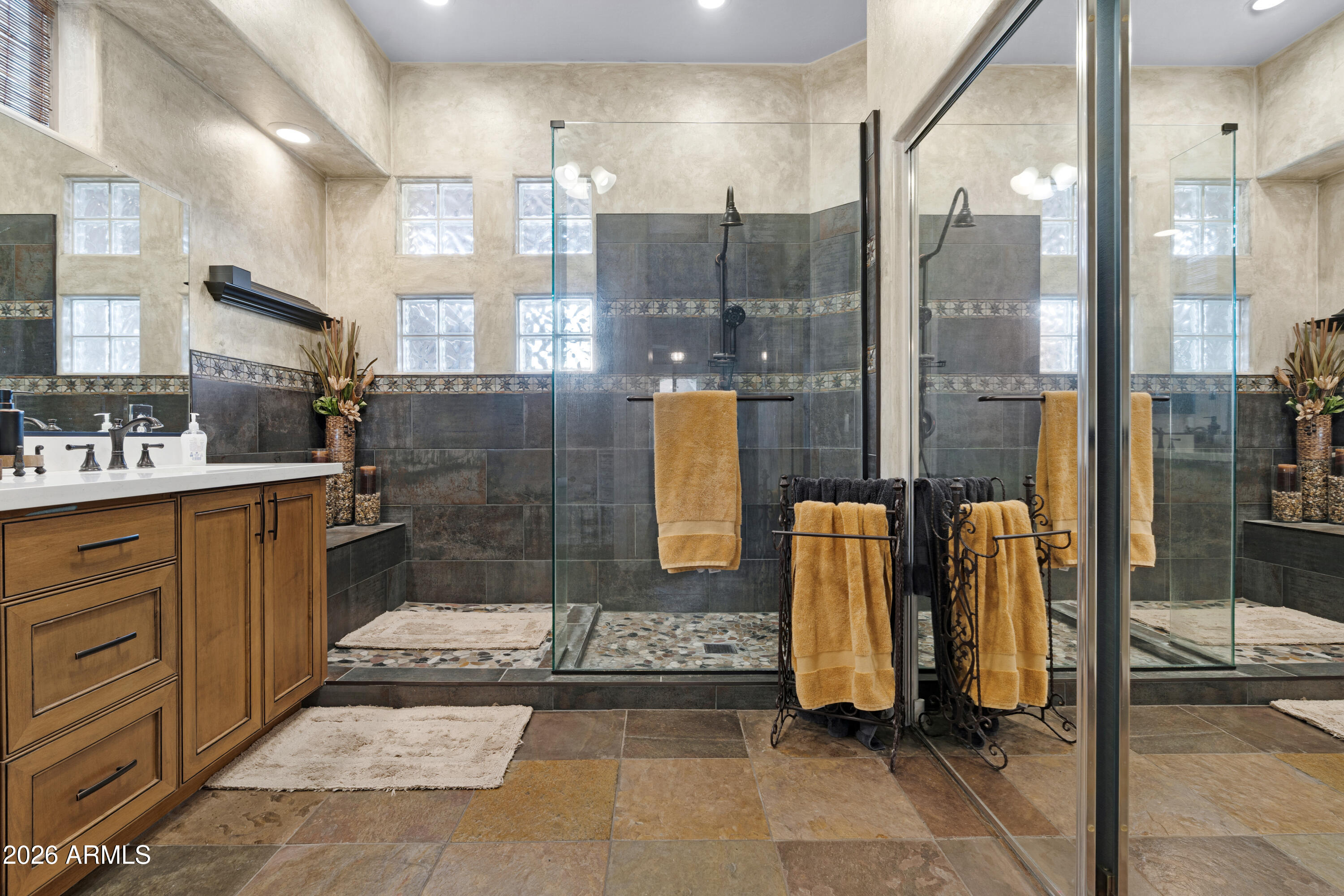 2107 East Beautiful Lane Phoenix, AZ 85042 - Photo 20 of 36 a bathroom with a tub a mirror and shower