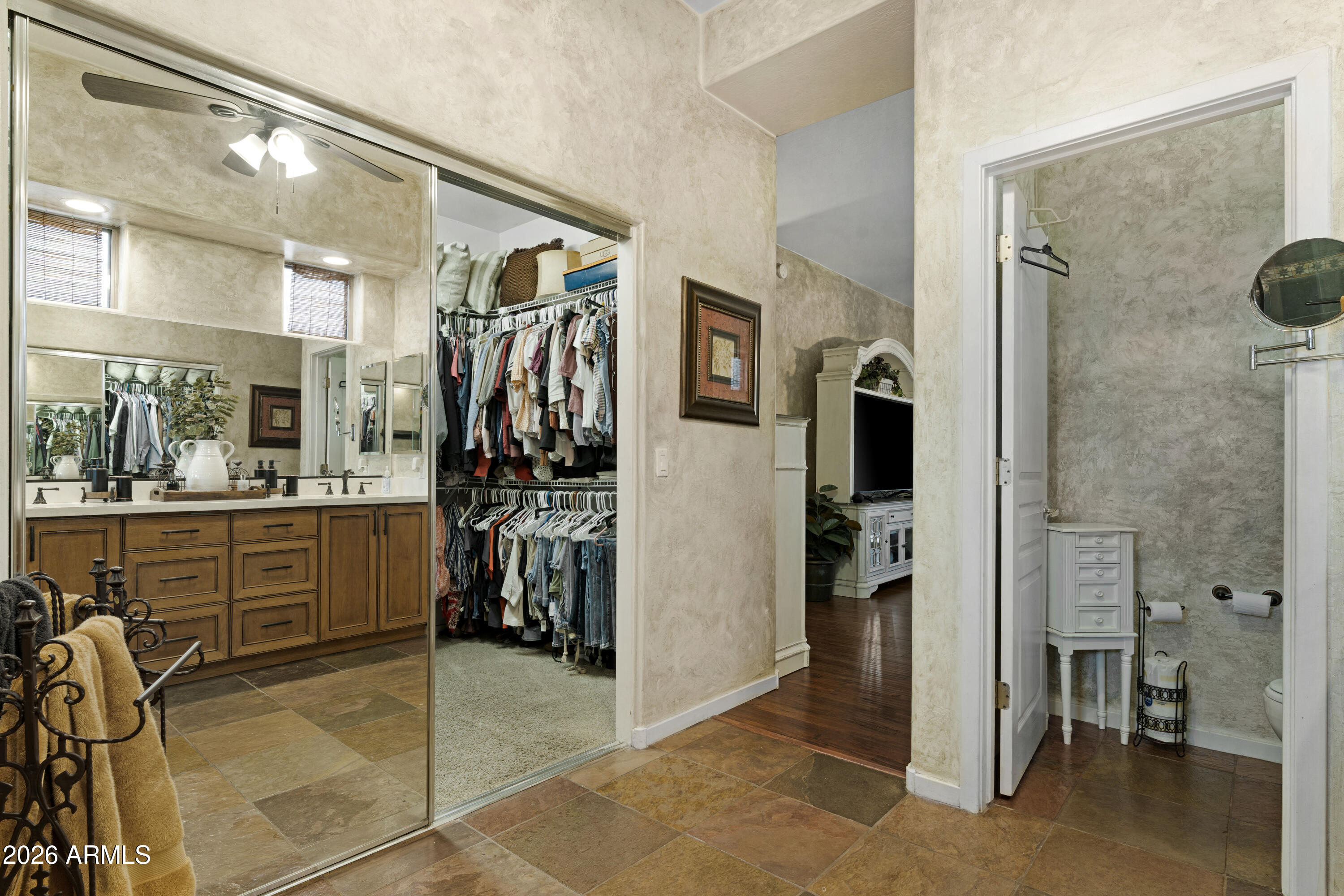 2107 East Beautiful Lane Phoenix, AZ 85042 - Photo 22 of 36 a view of a walk in closet and a bathroom