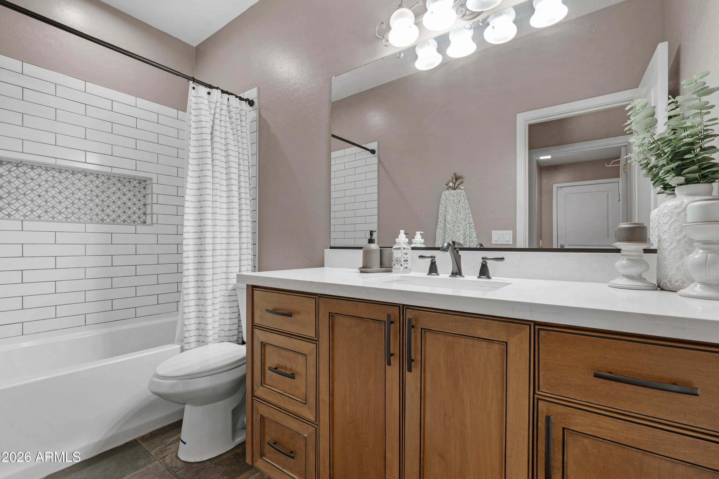 2107 East Beautiful Lane Phoenix, AZ 85042 - Photo 25 of 36 a bathroom with a toilet a sink a tub and mirror