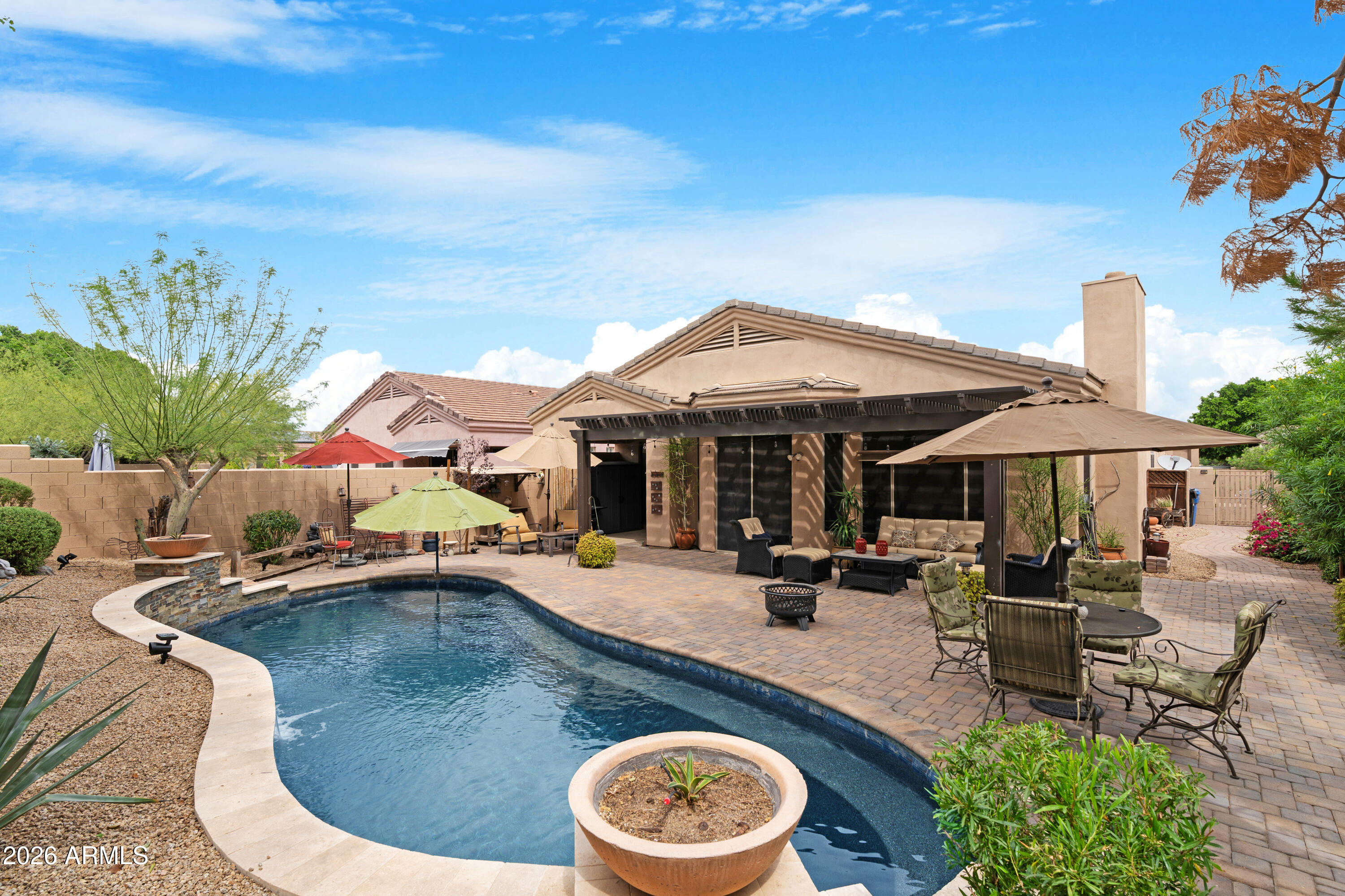 2107 East Beautiful Lane Phoenix, AZ 85042 - Photo 29 of 36 a patio with a table and chairs under an umbrella