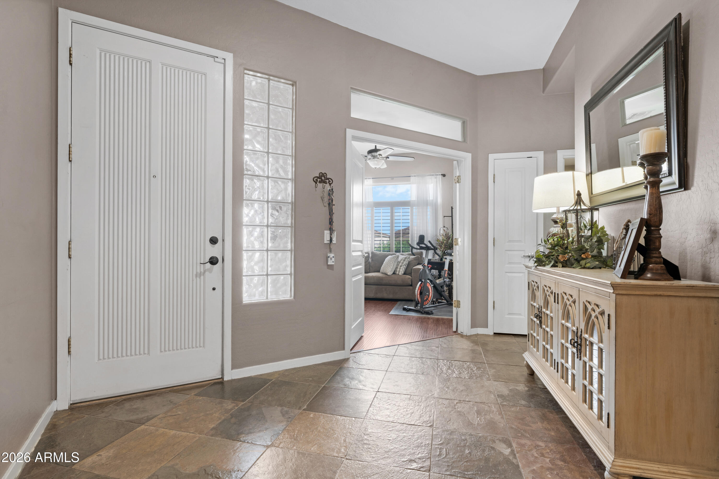 2107 East Beautiful Lane Phoenix, AZ 85042 - Photo 4 of 36 a view of a hallway to a livingroom and a livingroom with furniture