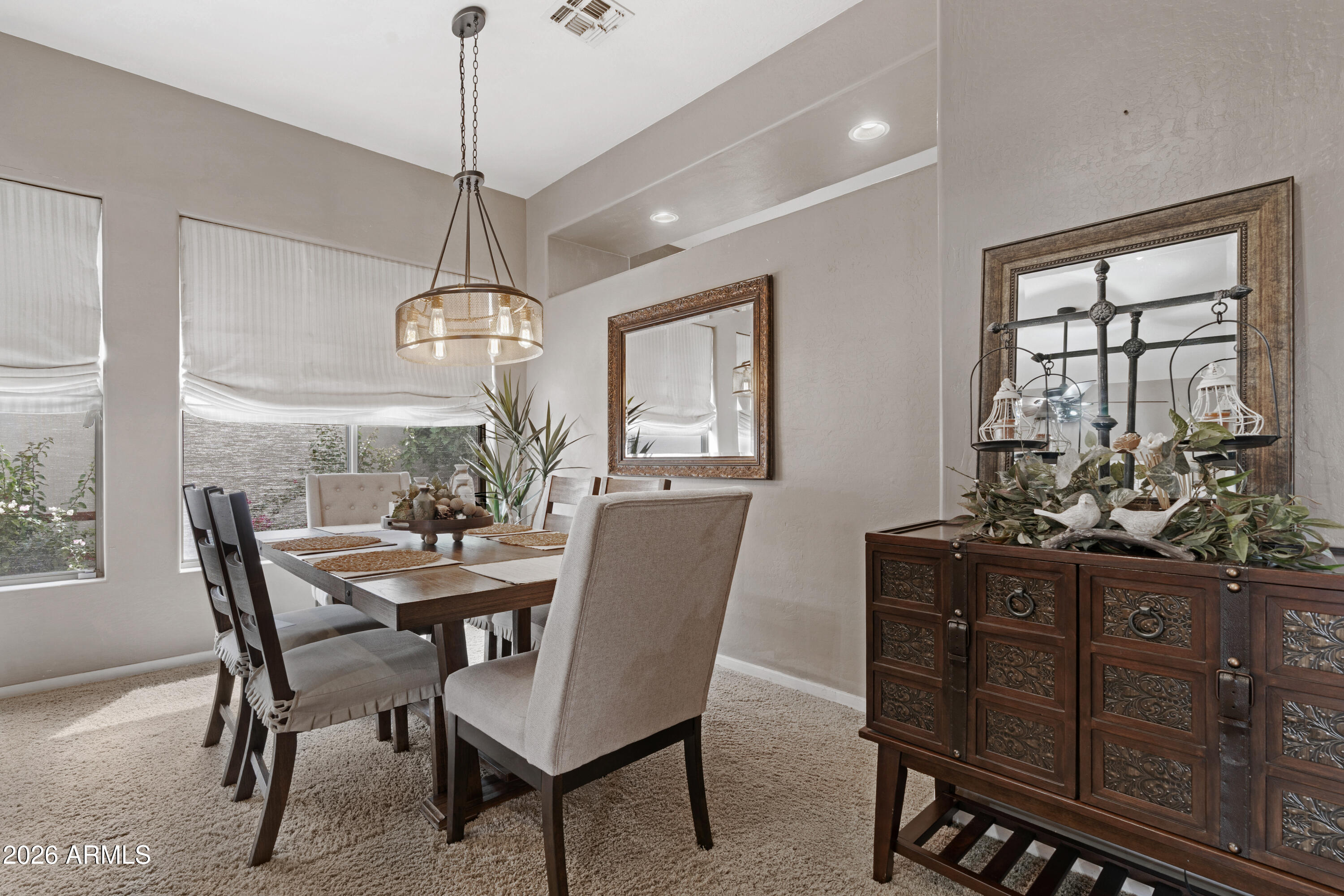 2107 East Beautiful Lane Phoenix, AZ 85042 - Photo 8 of 36 a view of a dining room with furniture window and wooden floor
