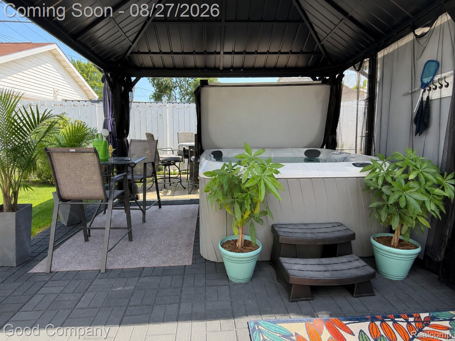 17941 East 13 Mile Road Fraser, MI 48026 - Photo 32 of 32 Paved patio featuring a built-in hot tub, dark metal gazebo with a solid roof, and privacy screens