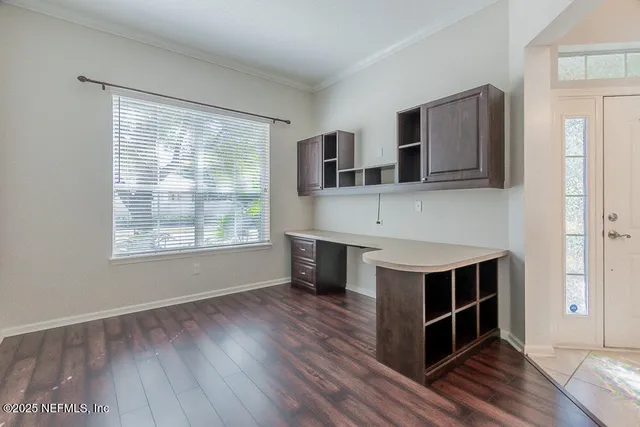 a view of a hallway with wooden cabinets