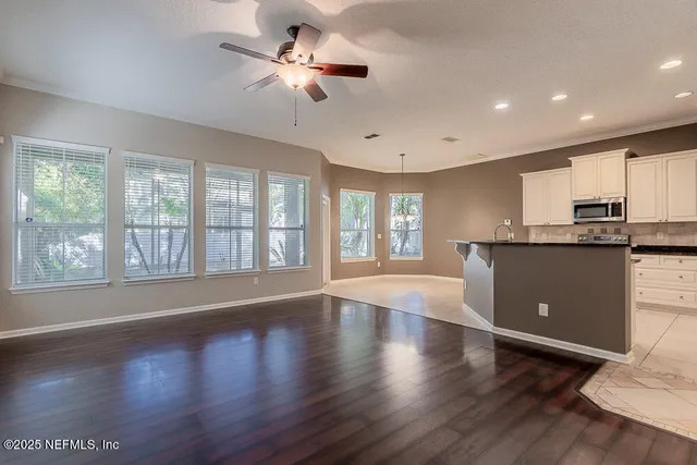 a view of empty room with wooden floor and fireplace