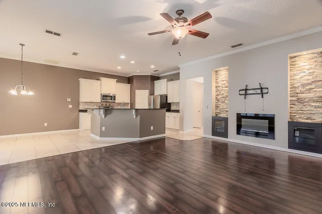 a view of a kitchen with a stove wooden cabinet and a kitchen counter top space