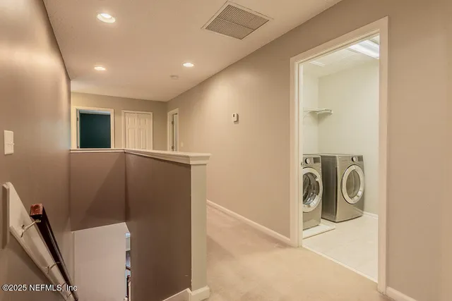 a spacious bathroom with a vanity a sink a mirror a bathtub and window